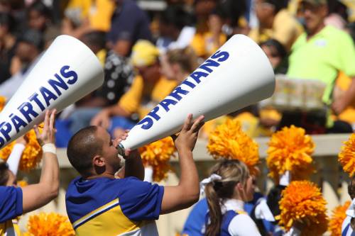 male cheerleader using a "spartan" megaphone at football game