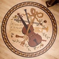 Inlaid wood floor medallion featuring a violin and other musical instruments