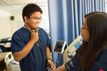 nursing student takes blood pressure of other student