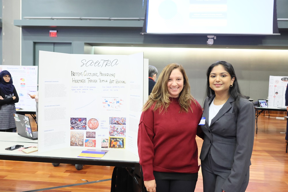 SAS student presenting at SVIC 2024 and posing for a picture with her SAS Program Manager 