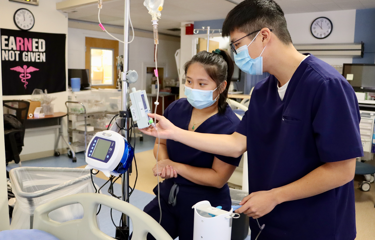 A Preceptor helps a BSN student learn important healthcare equipment.