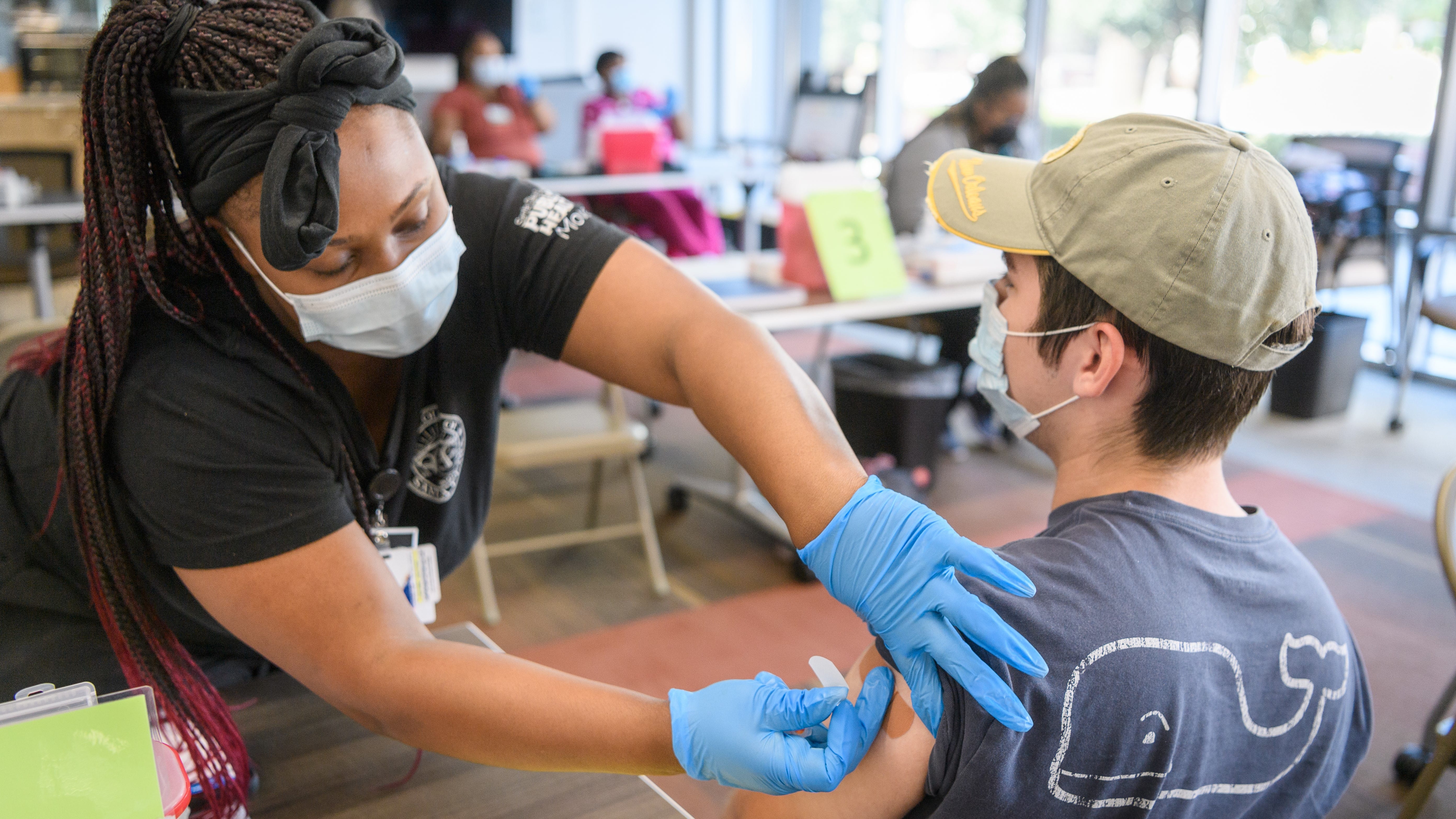 SJSU public health volunteer administering a vaccine to a student