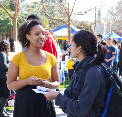 Students talking at campus event.