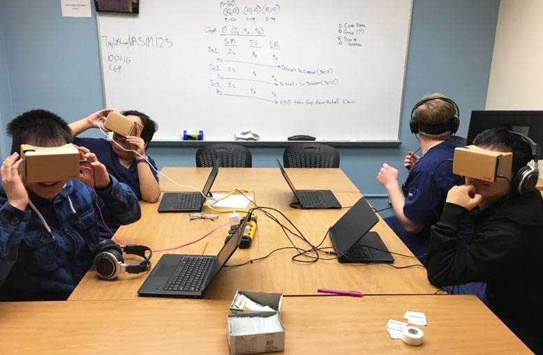 Students testing out the VR headsets in a classroom.