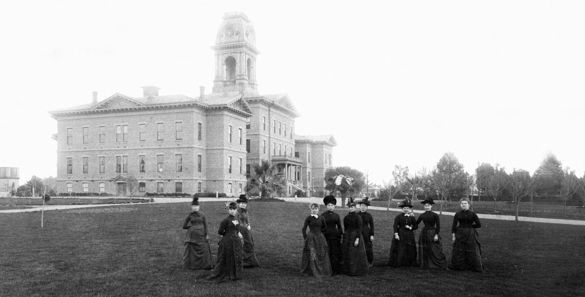 Historical image of female students in front of the Normal School.