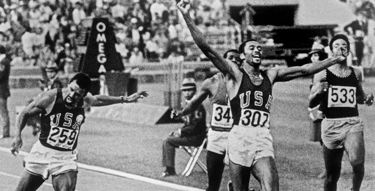 Tommie Smith reaching the finish line at the Olympics.