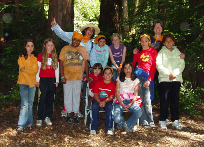Thalia with her Girl Scout troop in the woods.